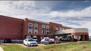 Airport affordable housing development - three story brick building with lobby entrance